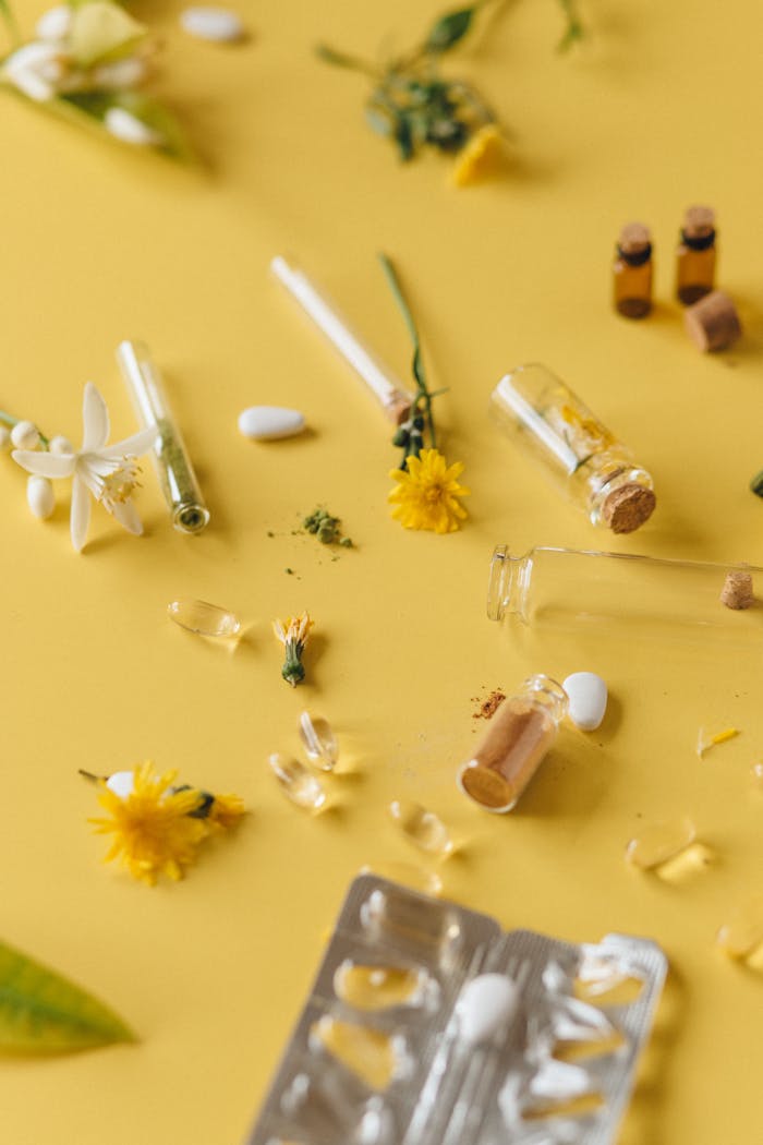 our-services-1 Flat lay of herbal medicines and natural ingredients with flowers on a yellow background.