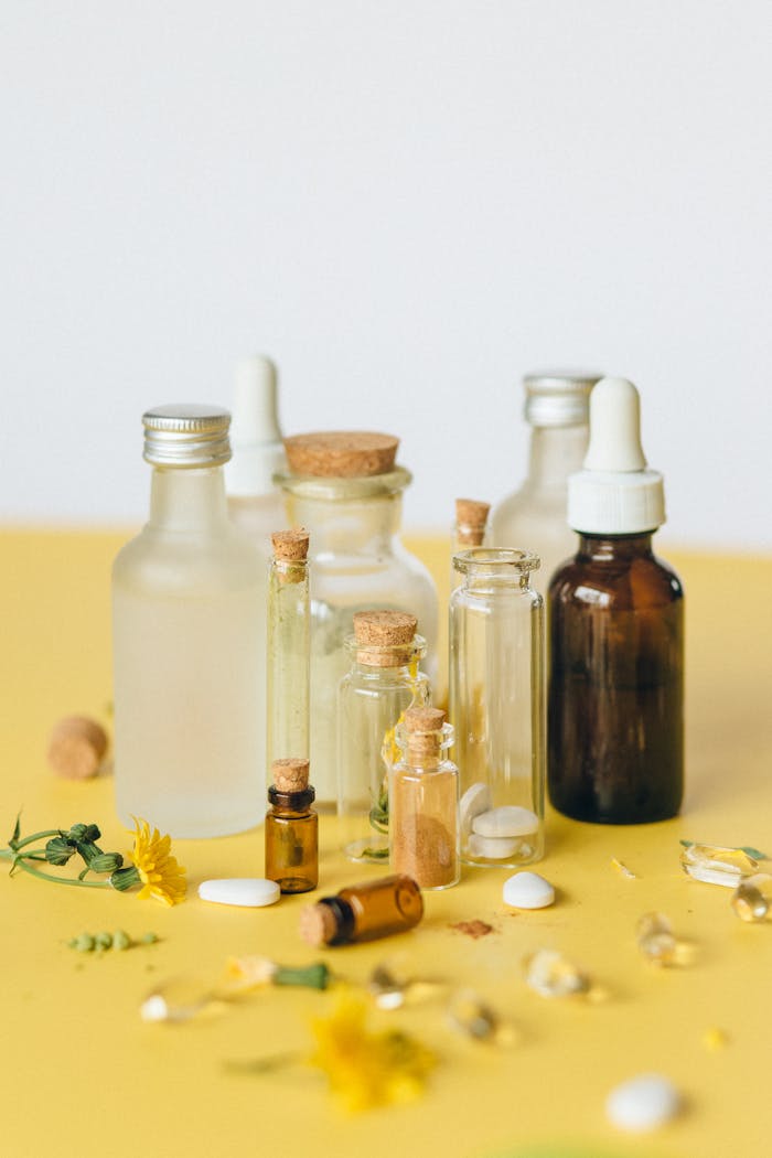 our-services-3 A collection of glass bottles with natural herbal medicines on a yellow background.